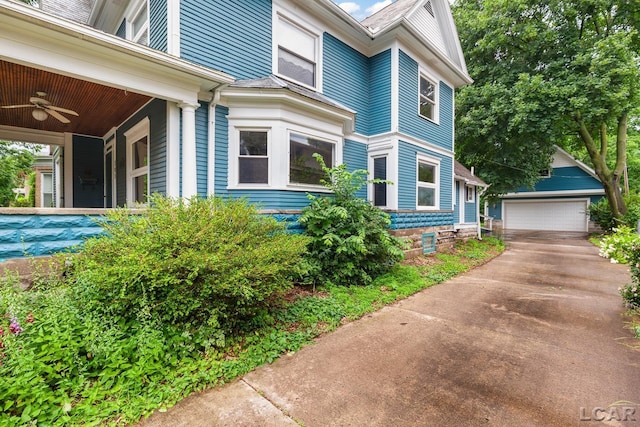 305 W Chicago Blvd, Tecumseh, MI 49286 - view of home's exterior with a ceiling fan, an outbuilding, and a detached garage