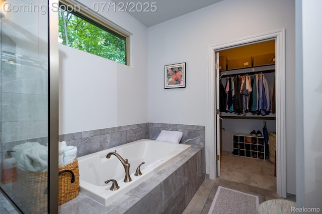 1079 Hampshire Ct, Rochester, MI 48307 - full bathroom featuring a bath, a walk in closet, and a shower stall