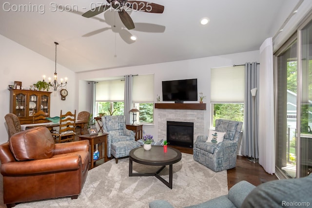 1079 Hampshire Ct, Rochester, MI 48307 - living area with wood finished floors, a chandelier, ceiling fan, lofted ceiling, and a fireplace