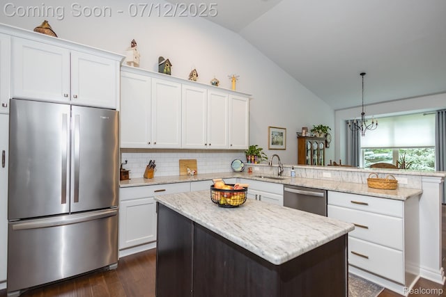 1079 Hampshire Ct, Rochester, MI 48307 - kitchen with stainless steel appliances, a peninsula, vaulted ceiling, dark wood finished floors, and white cabinets