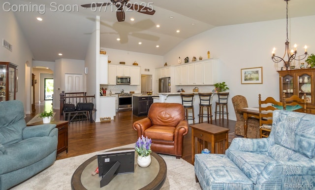 1079 Hampshire Ct, Rochester, MI 48307 - living area featuring ceiling fan, vaulted ceiling, arched walkways, dark wood-style floors, and a chandelier