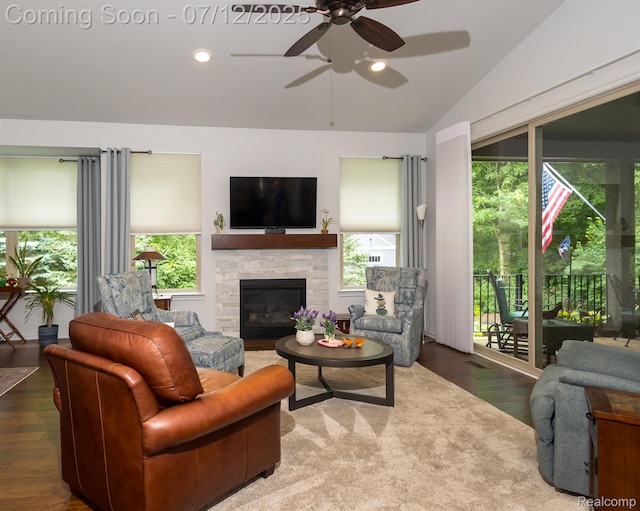 1079 Hampshire Ct, Rochester, MI 48307 - living area featuring vaulted ceiling, ceiling fan, wood finished floors, plenty of natural light, and a stone fireplace