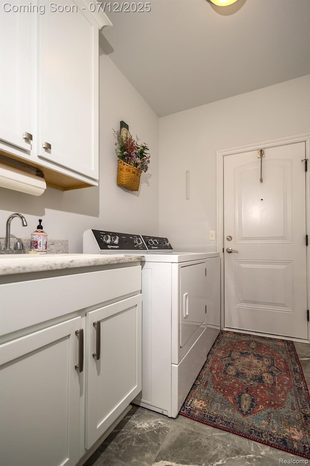 1079 Hampshire Ct, Rochester, MI 48307 - washroom featuring washer and dryer, cabinet space, and dark marble finish flooring