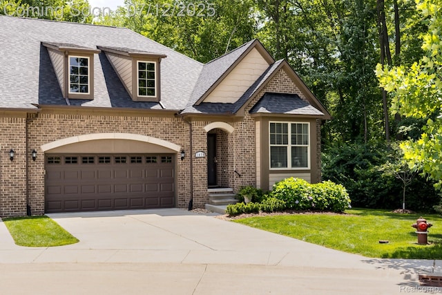1079 Hampshire Ct, Rochester, MI 48307 - view of front of house featuring brick siding, a shingled roof, concrete driveway, a garage, and a front yard