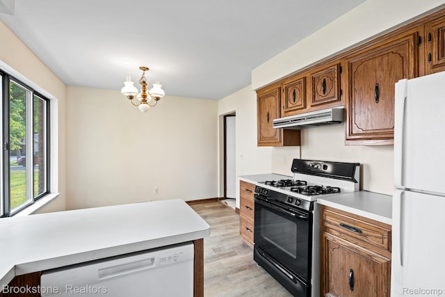 37746 Juniper Dr, Sterling Heights, MI 48310 - kitchen with white appliances, under cabinet range hood, light wood-style floors, light countertops, and a chandelier