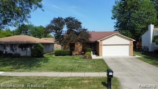 37746 Juniper Dr, Sterling Heights, MI 48310 - ranch-style house with an attached garage, a front yard, and concrete driveway