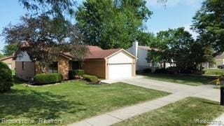 37746 Juniper Dr, Sterling Heights, MI 48310 - single story home with concrete driveway, a front yard, and an attached garage