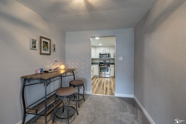 7768 Summerfield Rd, Lambertville, MI 48144 - dining room featuring light colored carpet and a textured ceiling