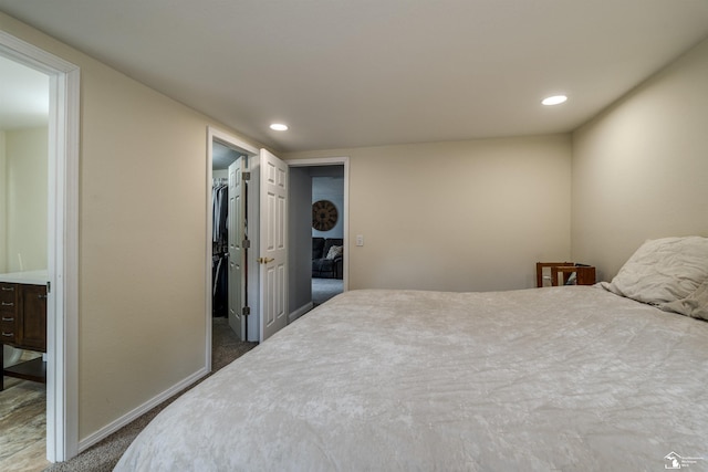 7768 Summerfield Rd, Lambertville, MI 48144 - carpeted bedroom featuring a walk in closet, recessed lighting, and connected bathroom