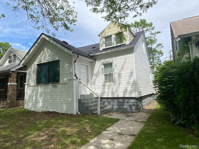 14646 San Juan Dr, Detroit, MI 48238 - view of front facade with entry steps and a shingled roof