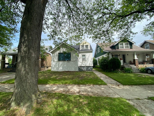 14646 San Juan Dr, Detroit, MI 48238 - view of front facade featuring a porch and a front lawn