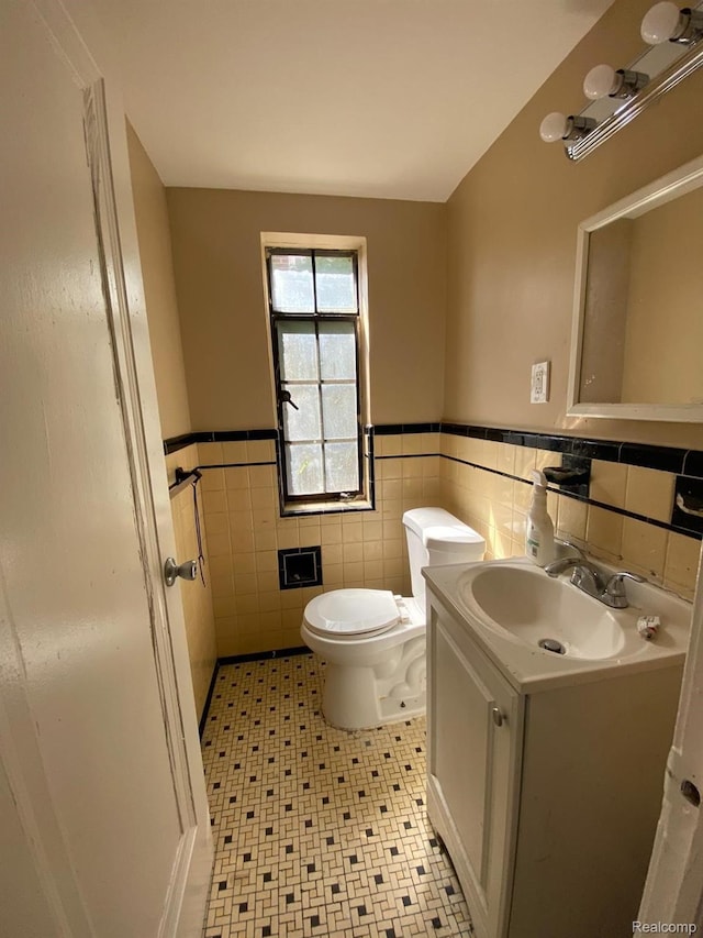 8063 Yolanda St, Detroit, MI 48234 - bathroom with vanity, wainscoting, tile walls, and tile patterned floors
