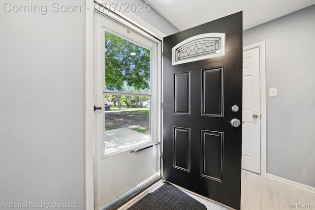 4714 Monterey Ave, Clarkston, MI 48348 - doorway to outside with baseboards and light marble finish flooring