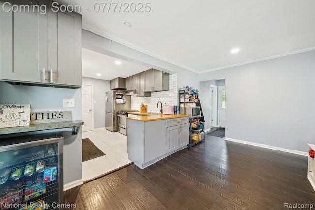 4714 Monterey Ave, Clarkston, MI 48348 - kitchen with butcher block countertops, gray cabinetry, wood finished floors, crown molding, and wine cooler