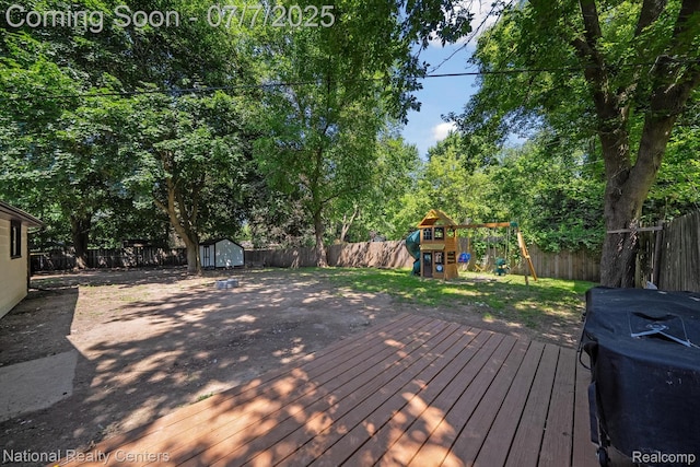 4714 Monterey Ave, Clarkston, MI 48348 - wooden deck with a playground, a shed, and a fenced backyard