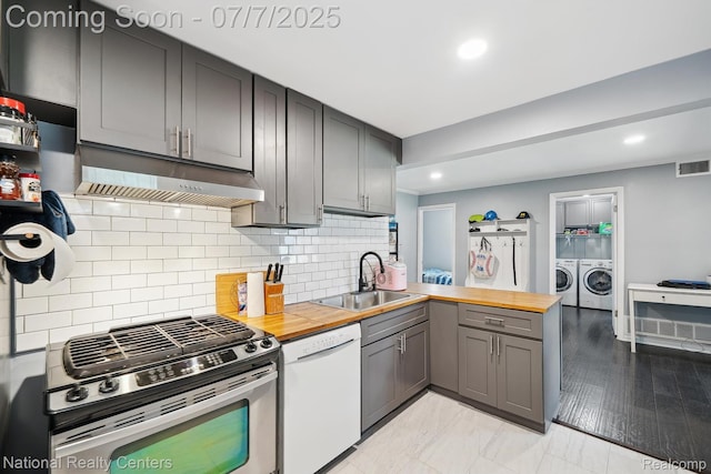 4714 Monterey Ave, Clarkston, MI 48348 - kitchen with dishwasher, gas range, butcher block countertops, under cabinet range hood, and separate washer and dryer