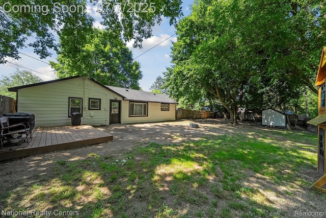 4714 Monterey Ave, Clarkston, MI 48348 - back of property featuring a fenced backyard, a storage shed, and a deck