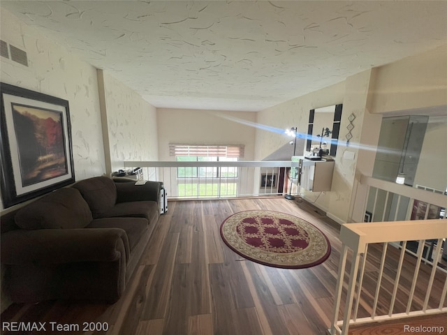 29203 Lake Park Dr, Farmington Hills, MI 48331 - living area with wood finished floors, vaulted ceiling, and a textured ceiling