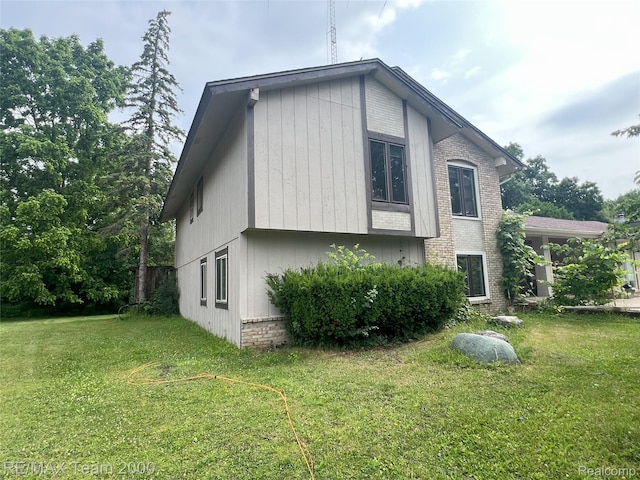 29203 Lake Park Dr, Farmington Hills, MI 48331 - view of home's exterior featuring a yard and brick siding