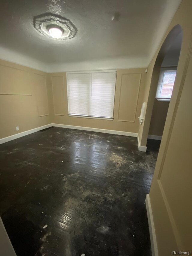 15355 Ward St, Detroit, MI 48227 - unfurnished dining area with arched walkways and concrete flooring