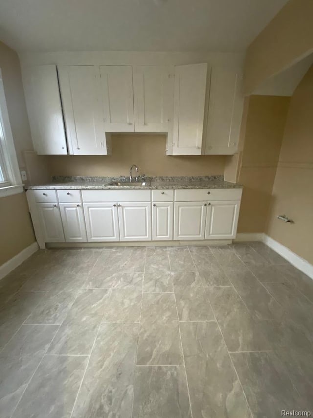15355 Ward St, Detroit, MI 48227 - kitchen featuring white cabinetry and light stone counters