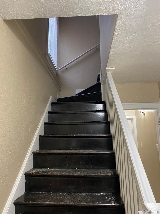15355 Ward St, Detroit, MI 48227 - stairs with a textured wall and a textured ceiling