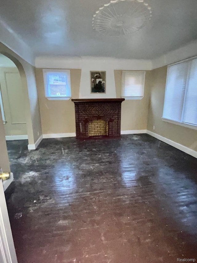 15355 Ward St, Detroit, MI 48227 - unfurnished living room with arched walkways and a brick fireplace