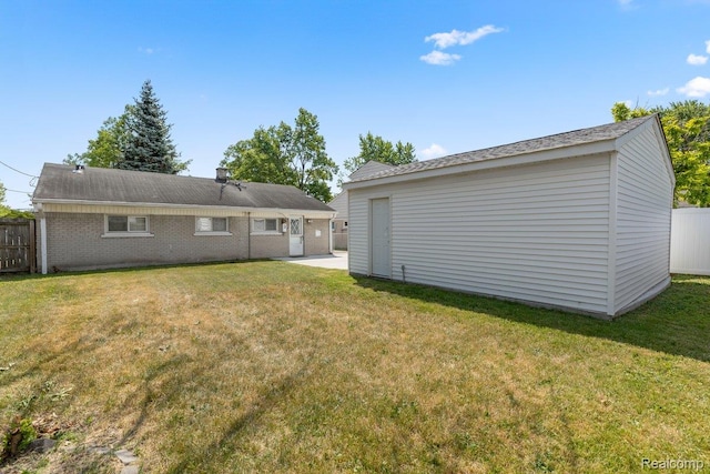 25615 Miracle Dr, Madison Heights, MI 48071 - rear view of house featuring an outdoor structure and brick siding