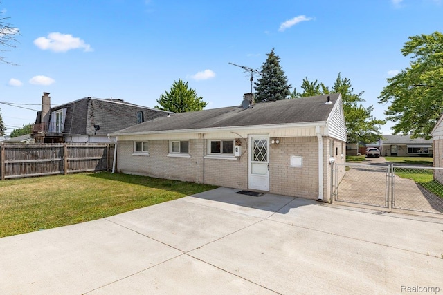 25615 Miracle Dr, Madison Heights, MI 48071 - rear view of house featuring a gate, a patio, brick siding, a chimney, and roof with shingles