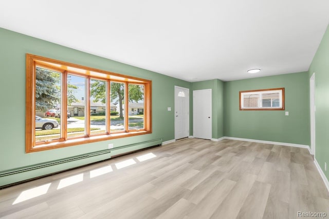 25615 Miracle Dr, Madison Heights, MI 48071 - entryway with light wood-style flooring and a baseboard heating unit