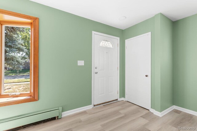 25615 Miracle Dr, Madison Heights, MI 48071 - foyer featuring a baseboard heating unit and light wood-style flooring