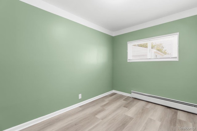 25615 Miracle Dr, Madison Heights, MI 48071 - spare room with a baseboard heating unit and light wood-type flooring