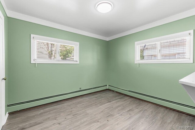 25615 Miracle Dr, Madison Heights, MI 48071 - empty room featuring light wood-style flooring and baseboard heating