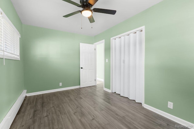 25615 Miracle Dr, Madison Heights, MI 48071 - unfurnished bedroom with a baseboard heating unit, wood finished floors, ceiling fan, and a closet