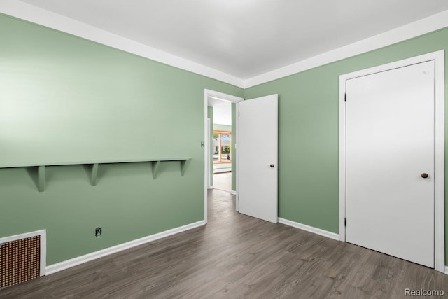 25615 Miracle Dr, Madison Heights, MI 48071 - unfurnished bedroom with wood finished floors and baseboards