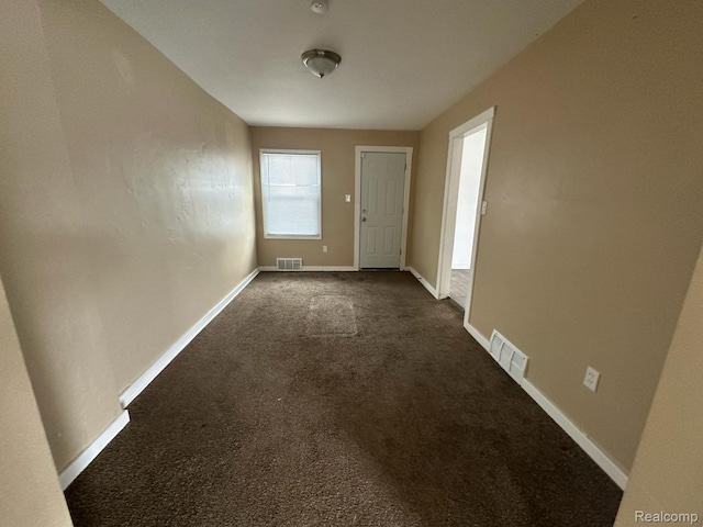 5030 Hereford St, Detroit, MI 48224 - empty room featuring dark carpet and baseboards