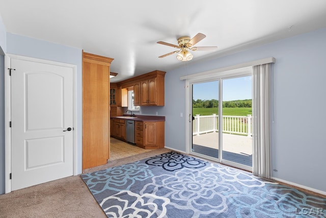 4100 Hunt Rd, Adrian, MI 49221 - kitchen with light carpet, ceiling fan, dishwasher, and brown cabinetry