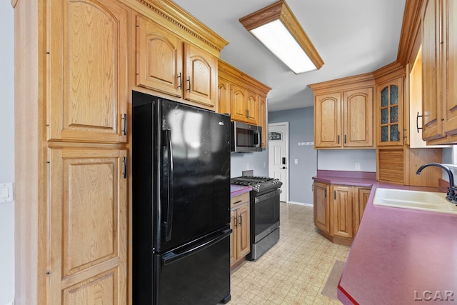 4100 Hunt Rd, Adrian, MI 49221 - kitchen with freestanding refrigerator, range with gas stovetop, stainless steel microwave, light floors, and glass insert cabinets