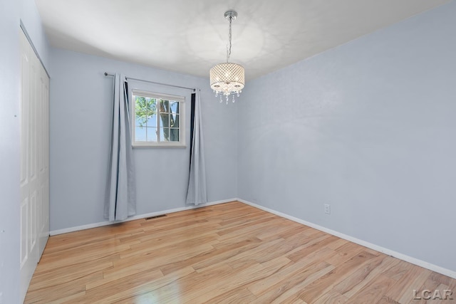 4100 Hunt Rd, Adrian, MI 49221 - spare room with a chandelier and wood finished floors