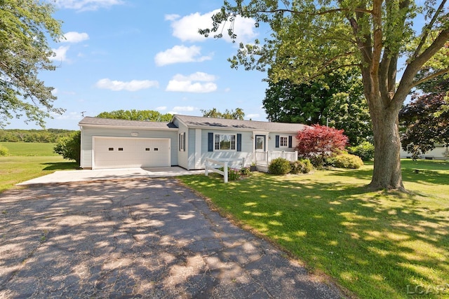 4100 Hunt Rd, Adrian, MI 49221 - single story home with a garage, asphalt driveway, and a front lawn