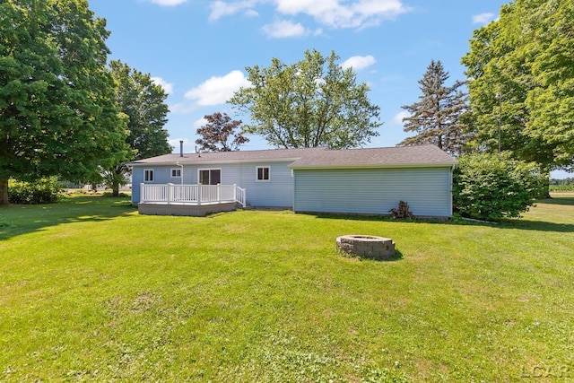 4100 Hunt Rd, Adrian, MI 49221 - back of house with a fire pit, a deck, and a yard