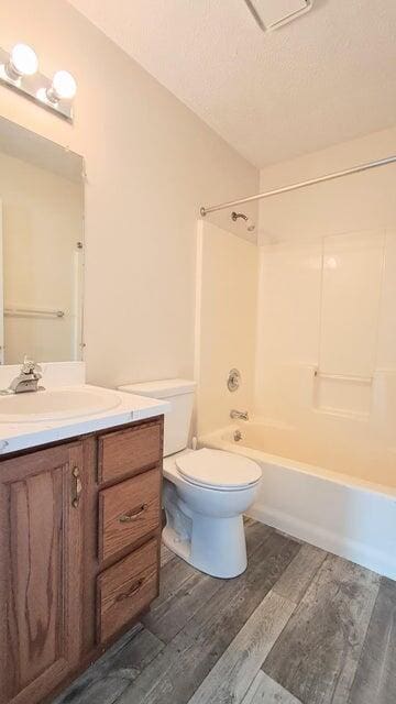 4763 Weston Ave, Kalamazoo, MI 49006 - bathroom with wood finished floors, vanity, shower / tub combination, and a textured ceiling