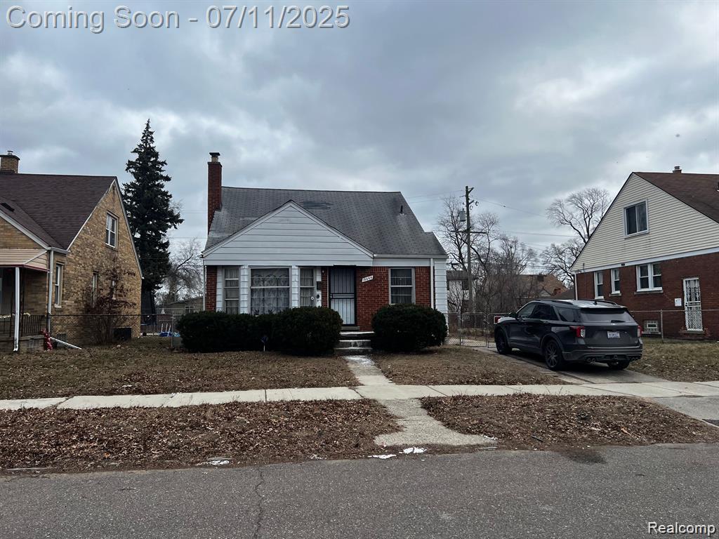 19444 Yonka St, Detroit, MI 48234 - bungalow-style house with brick siding, driveway, and a chimney