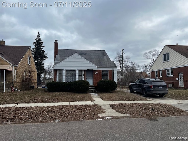 19444 Yonka St, Detroit, MI 48234 - bungalow-style house with brick siding, driveway, and a chimney