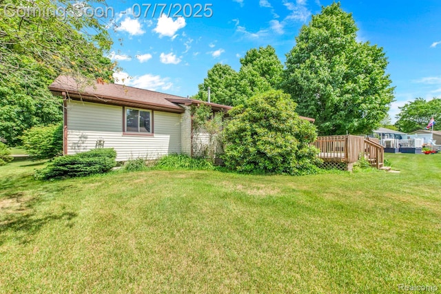 3447 Woodvalley Dr, Lapeer, MI 48446 - view of grassy yard with a deck