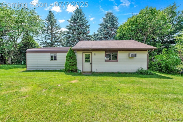 3447 Woodvalley Dr, Lapeer, MI 48446 - back of house featuring a lawn and a wall unit AC