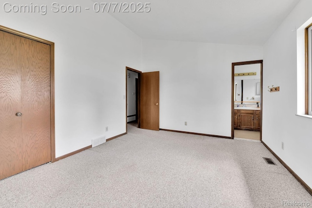 3447 Woodvalley Dr, Lapeer, MI 48446 - unfurnished bedroom featuring light carpet, ensuite bathroom, and high vaulted ceiling