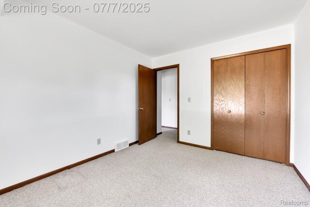 3447 Woodvalley Dr, Lapeer, MI 48446 - unfurnished bedroom featuring light colored carpet and a closet