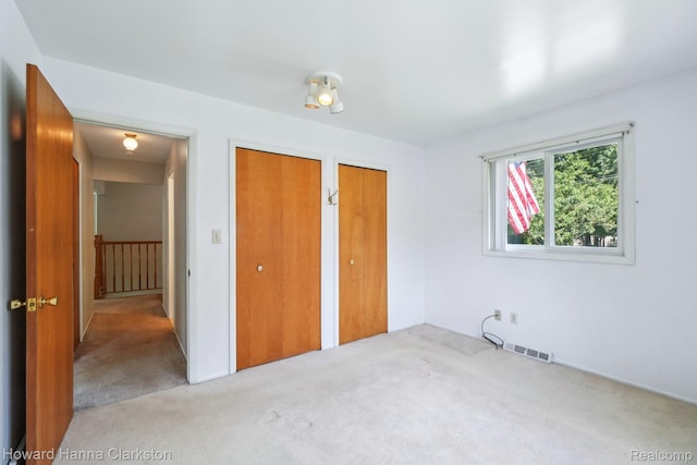 4220 England Beach Rd, White Lake, MI 48383 - unfurnished bedroom with two closets and carpet floors