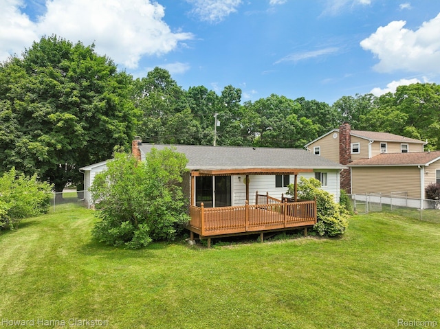 4220 England Beach Rd, White Lake, MI 48383 - rear view of property featuring a wooden deck, a fenced backyard, and a chimney